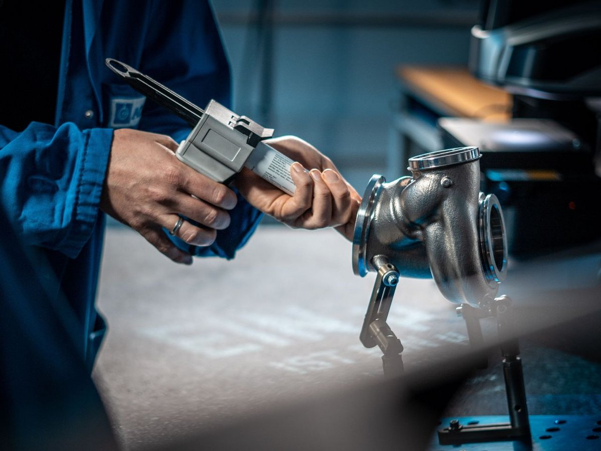 an employee injects a silicone compound into a turbocharger